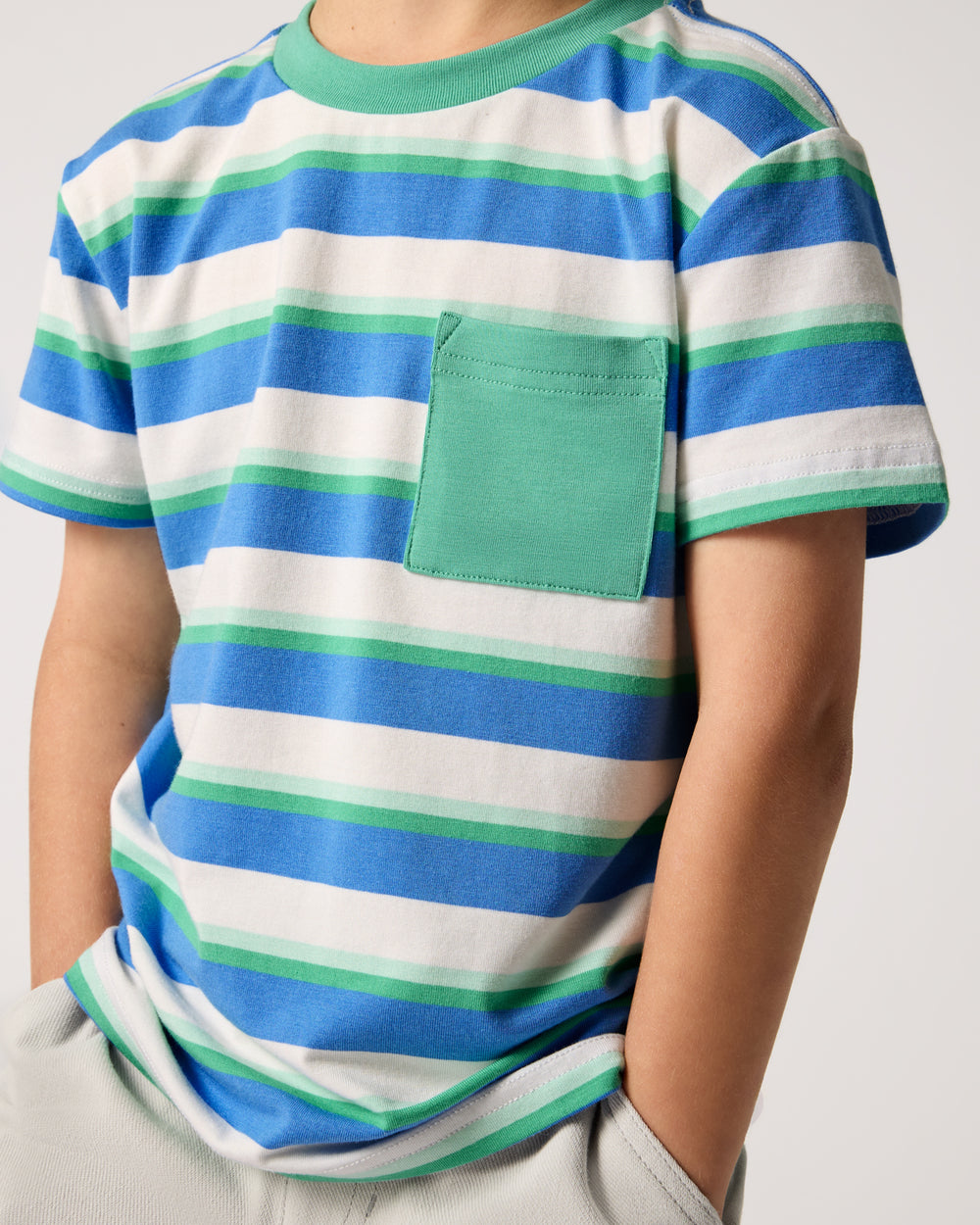Close up of boy wearing the Blue Bolt Stripes Relaxed Pocket Tee