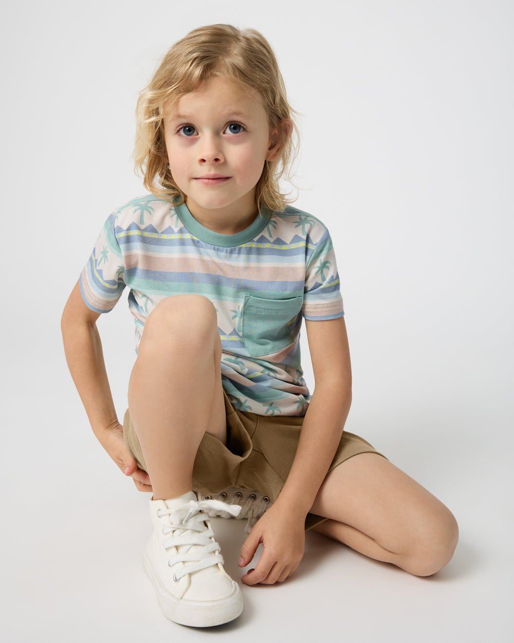 Sitting child wearing the Swell Stripes Relaxed Pocket Tee