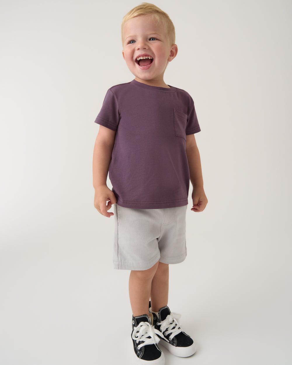 Boy wearing the Vintage Plum Relaxed Pocket Tee with gray shorts