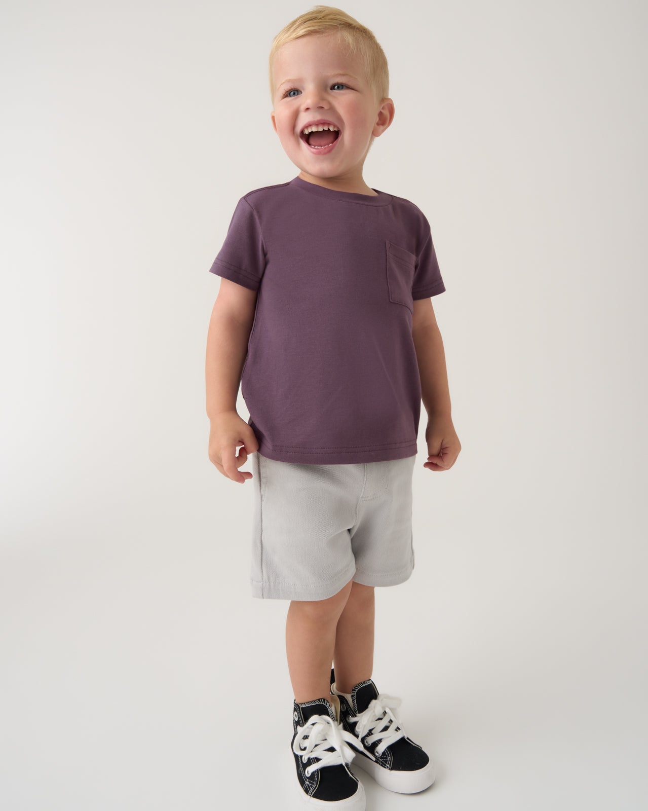 Boy wearing the Vintage Plum Relaxed Pocket Tee with gray shorts