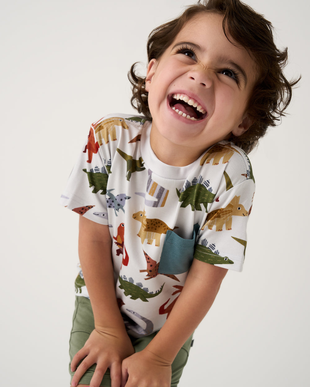 Smiling child wearing the Roar & Explore Relaxed Pocket Tee