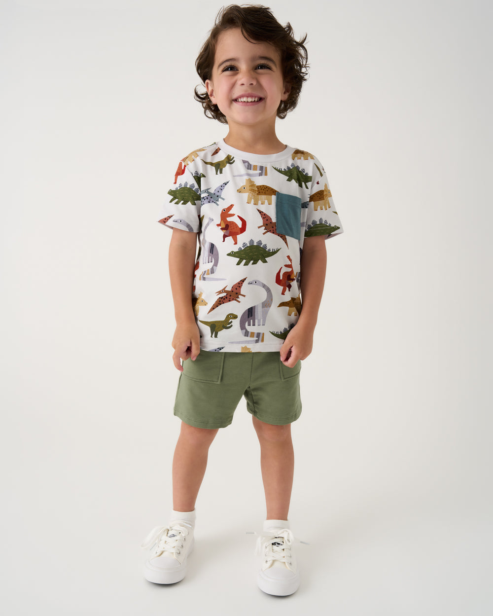 Boy wearing the Roar & Explore Relaxed Pocket Tee with green shorts