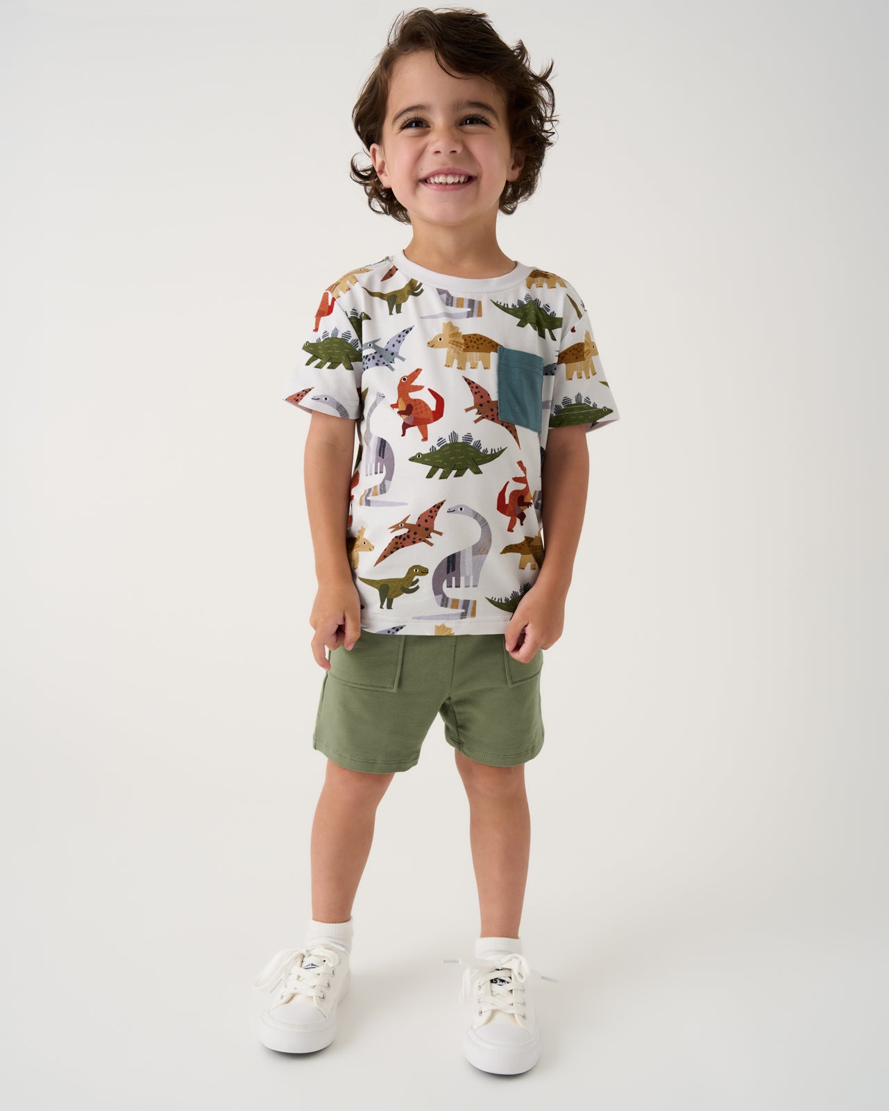 Boy wearing the Roar & Explore Relaxed Pocket Tee with green shorts