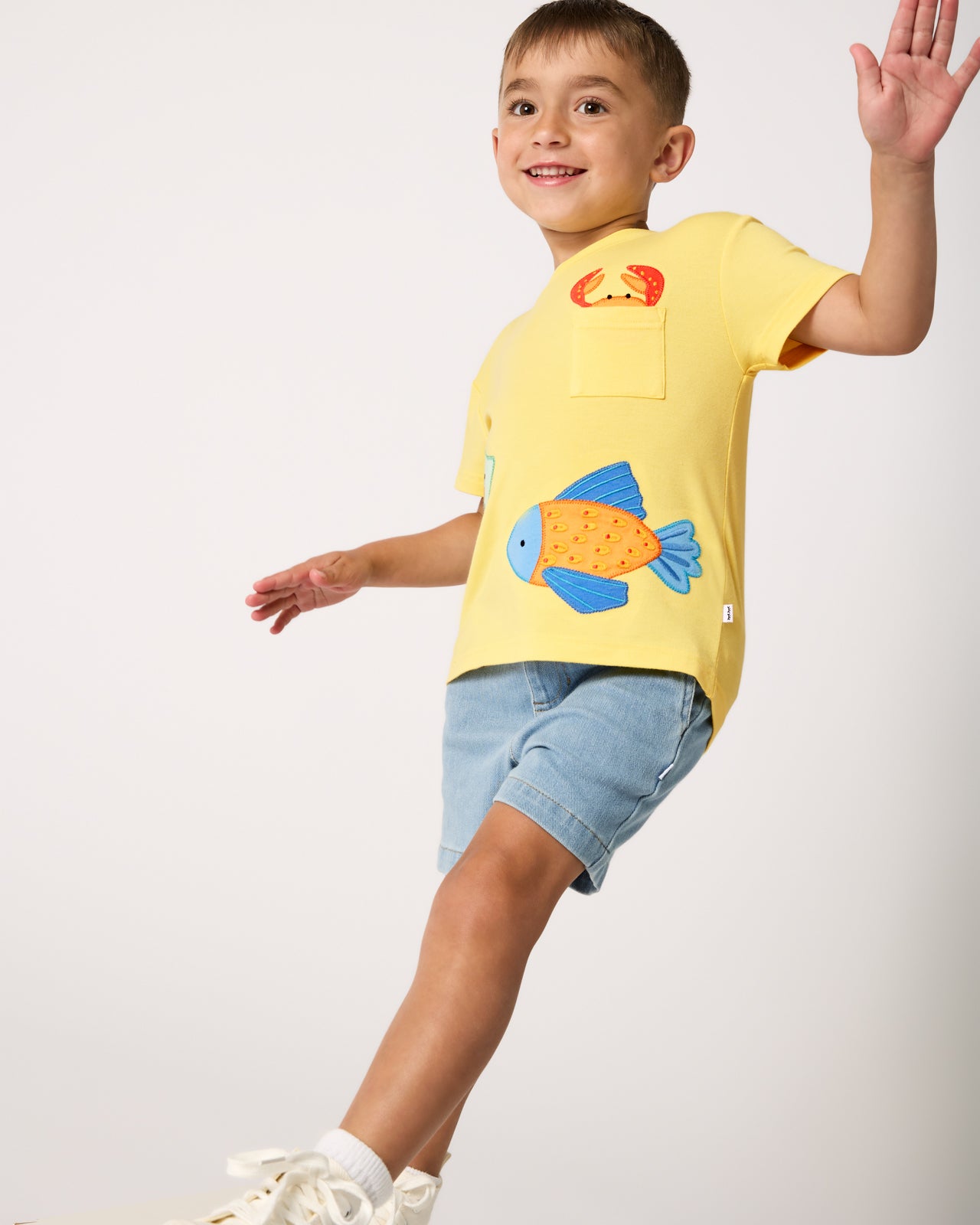Boy wearing the School of Friends Relaxed Pocket Tee with denim shorts