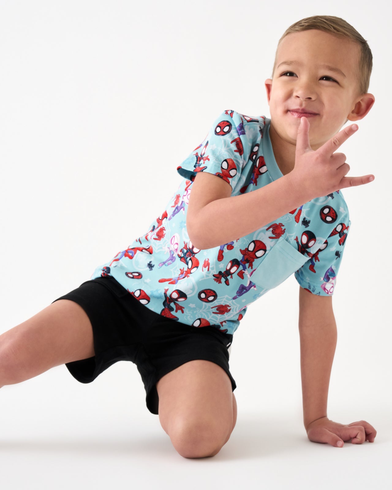 Posing boy wearing the Spidey & Friends Tiny Webs Relaxed Pocket Tee