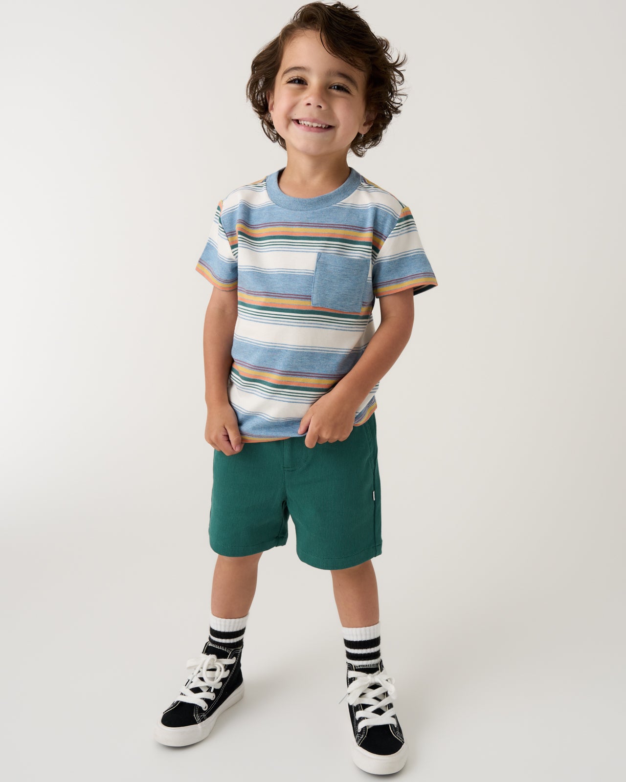 Boy wearing the Explorer Stripes Relaxed Pocket Tee and green shorts