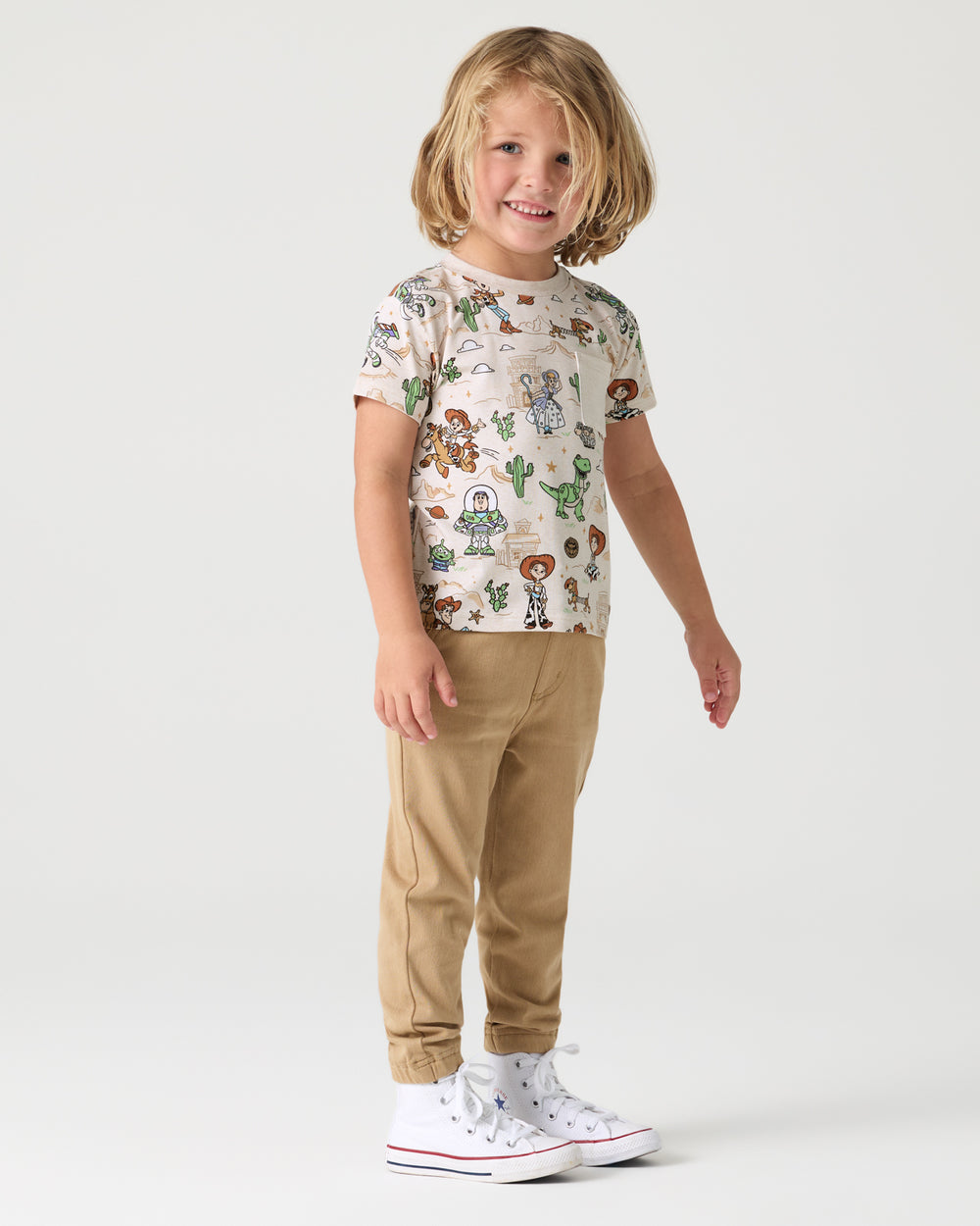 Boy wearing the Disney & Pixar Woody's Wild West Relaxed Pocket Tee with khaki joggers