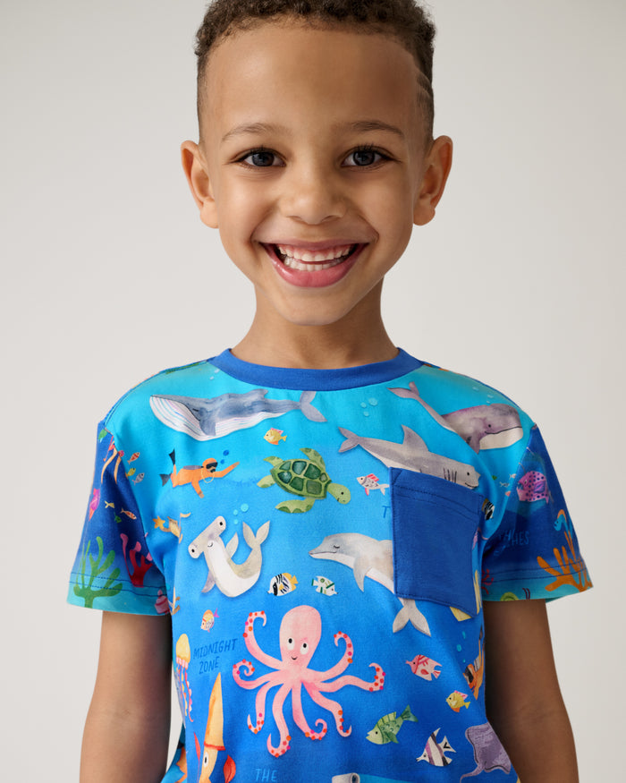 Close up of boy wearing the Underwater Discovery Relaxed Pocket Tee
