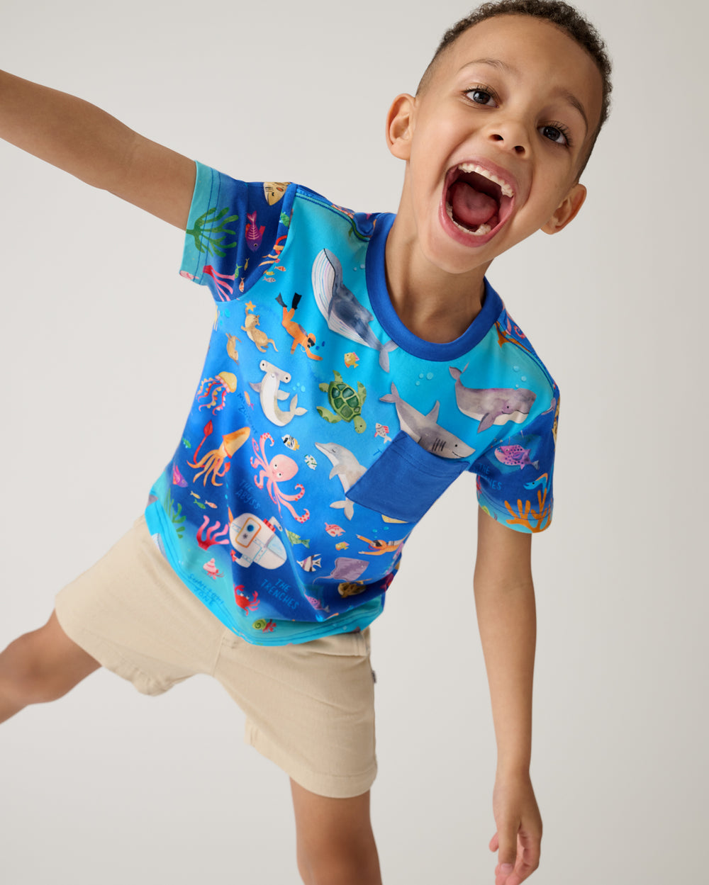 Posing boy wearing the Underwater Discovery Relaxed Pocket Tee