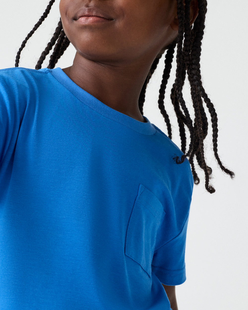 Close up of boy wearing the Jay Blue Relaxed Pocket Tee