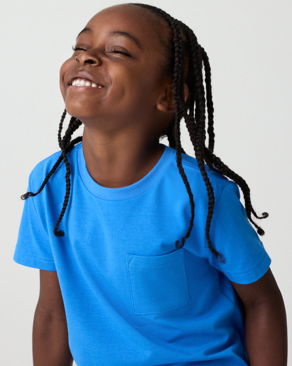 Smiling child wearing the Jay Blue Short Sleeve Relaxed Pocket Tee