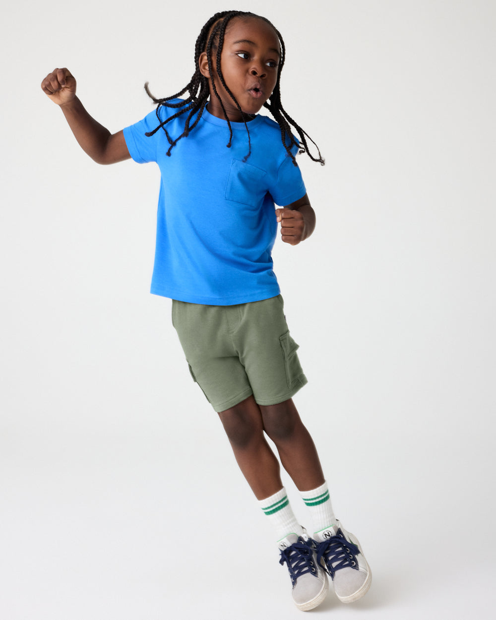 Boy wearing the Jay Blue Relaxed Pocket Tee with Green Shorts