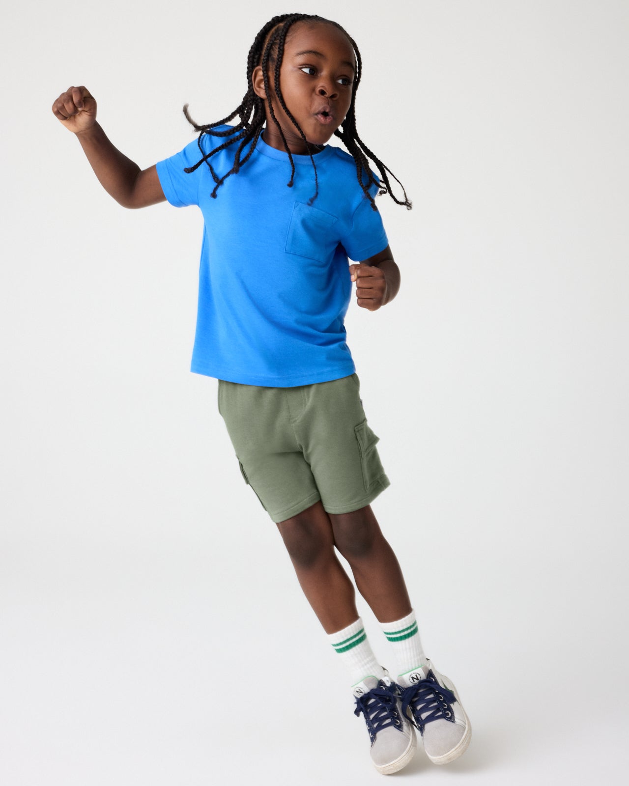 Boy wearing the Jay Blue Relaxed Pocket Tee with Green Shorts