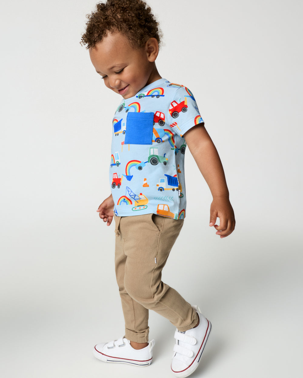 Boy wearing the Rainbow Trucks Relaxed Pocket Tee with khaki joggers