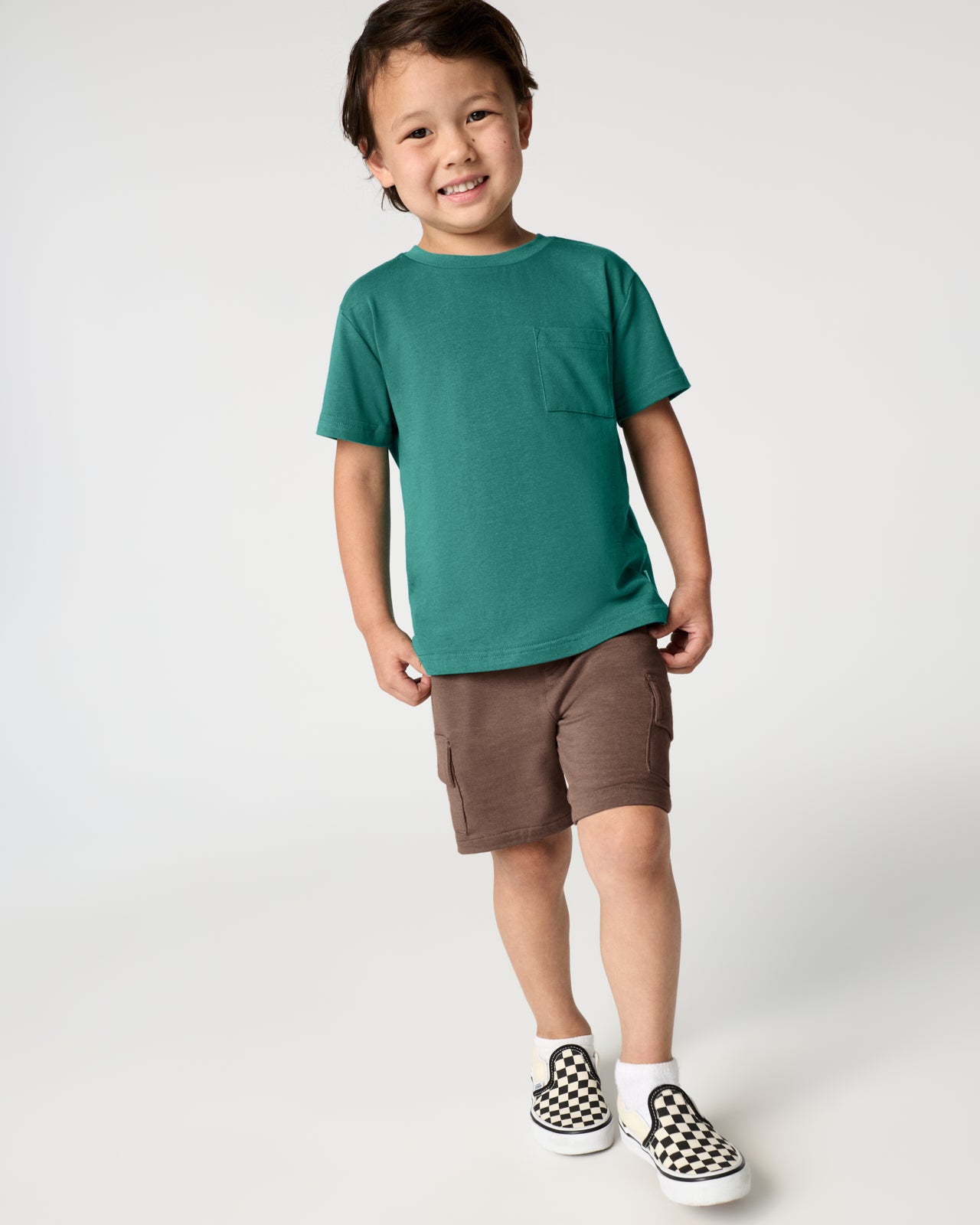 Boy wearing the Emerald Isle Relaxed Pocket Tee with brown shorts