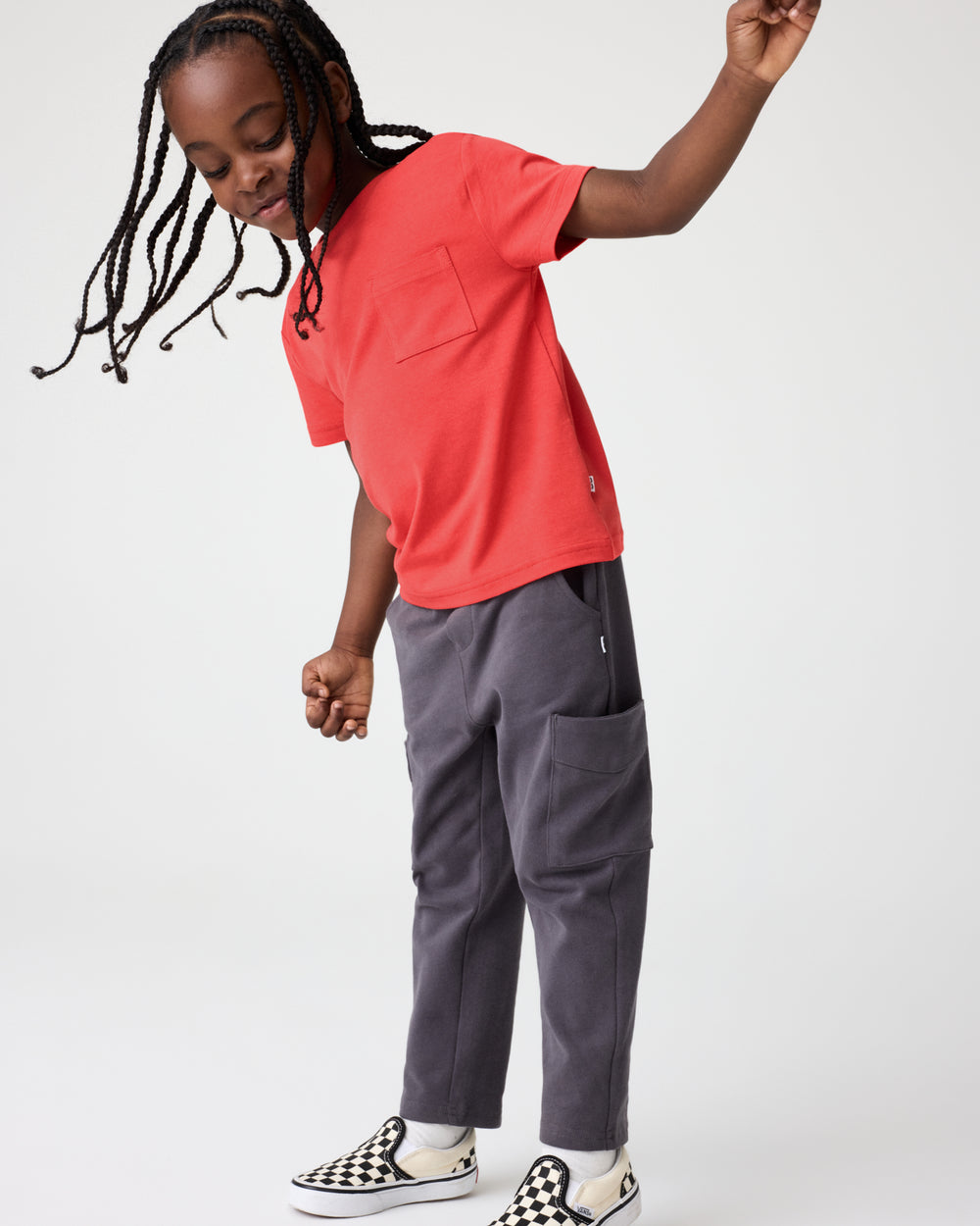 Boy wearing the Red Ember Relaxed Pocket Tee with Washed Black cargos