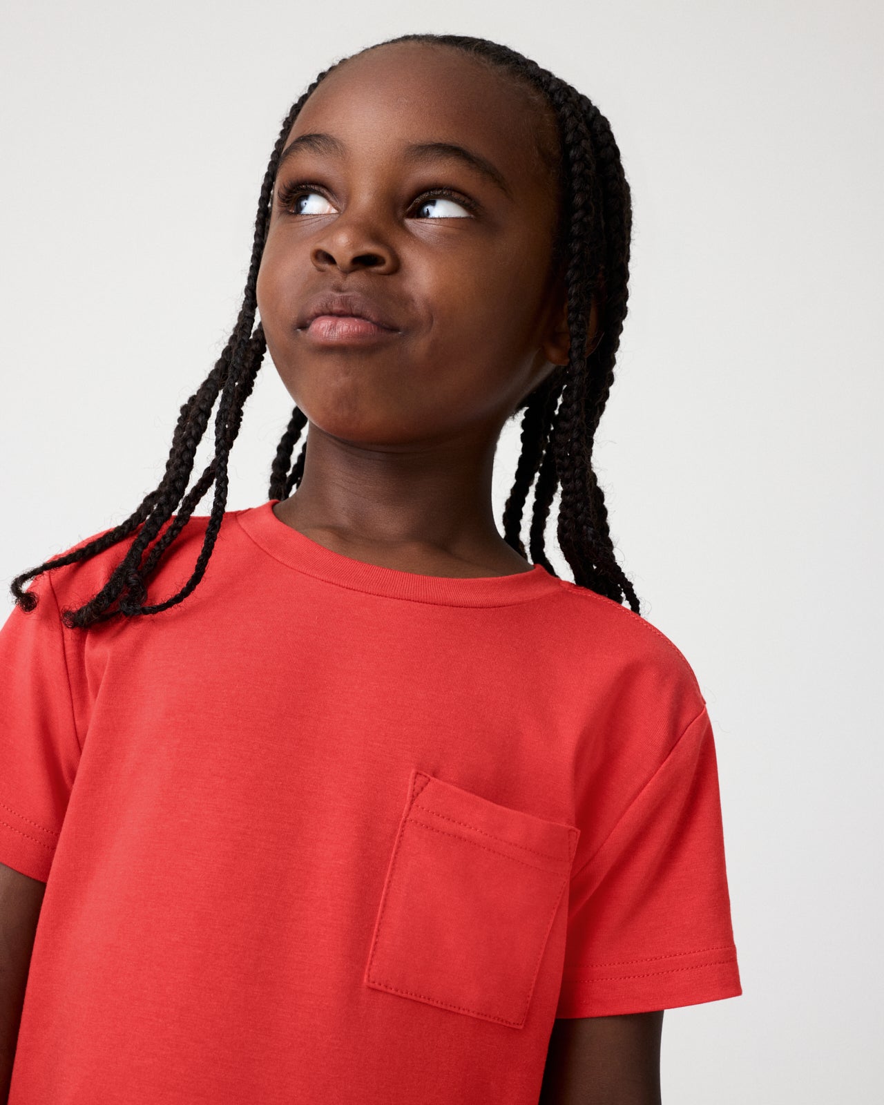 Close up of boy wearing the Red Ember Relaxed Pocket Tee