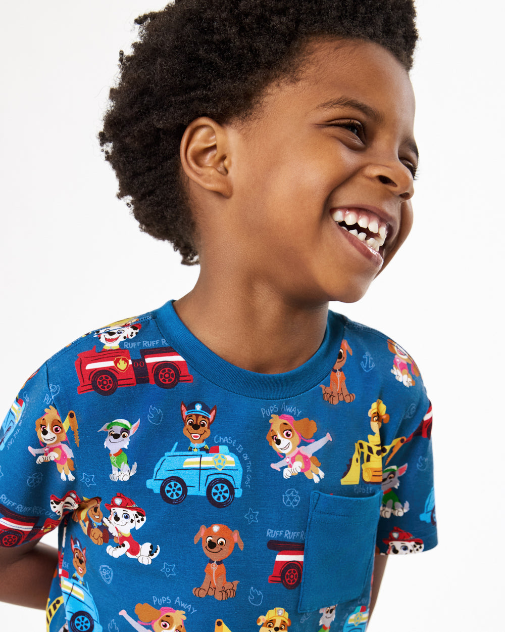 Close up of boy wearing the PAW Patrol Adventure Bay Heroes Relaxed Pocket Tee with gray shorts