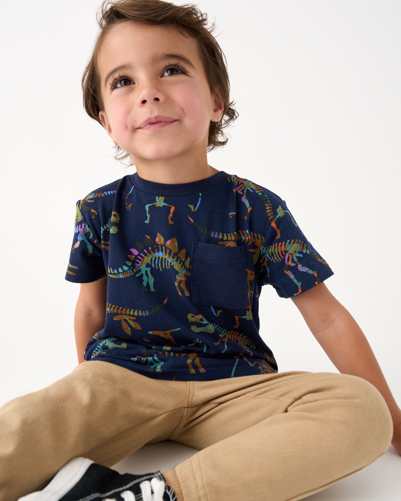 Boy wearing the Fossil Quest Relaxed Pocket Tee with khaki joggers