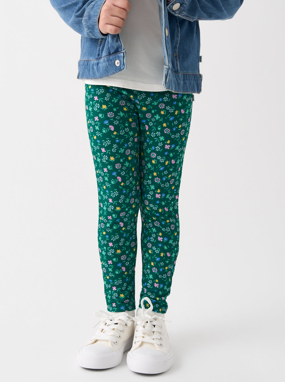 Child wearing the Emerald Meadow Legging with white sneakers