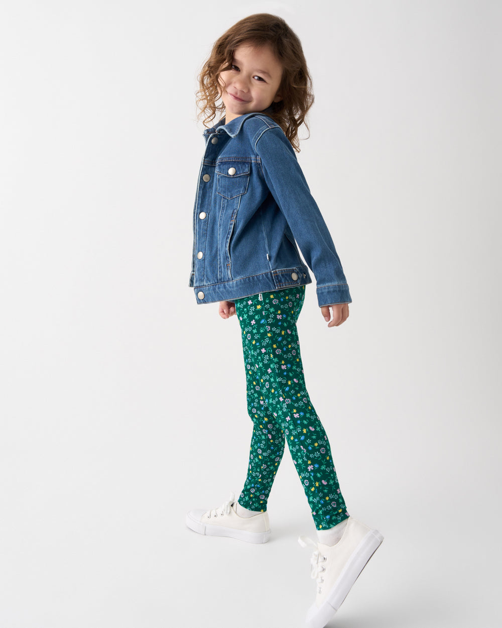 Girl wearing the Emerald Meadow Legging with a denim jacket