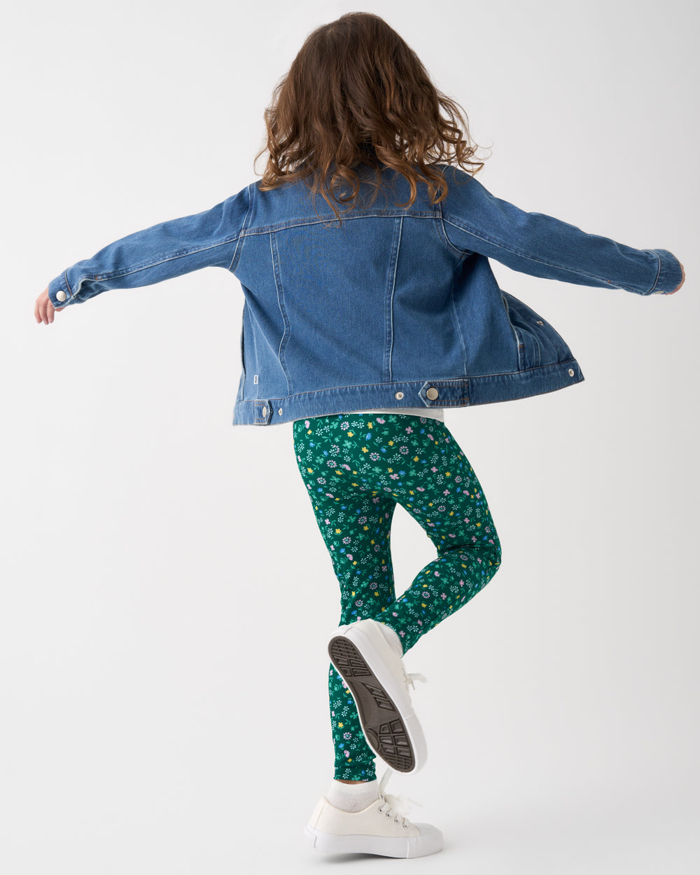 Child in motion wearing the Emerald Meadow Legging
