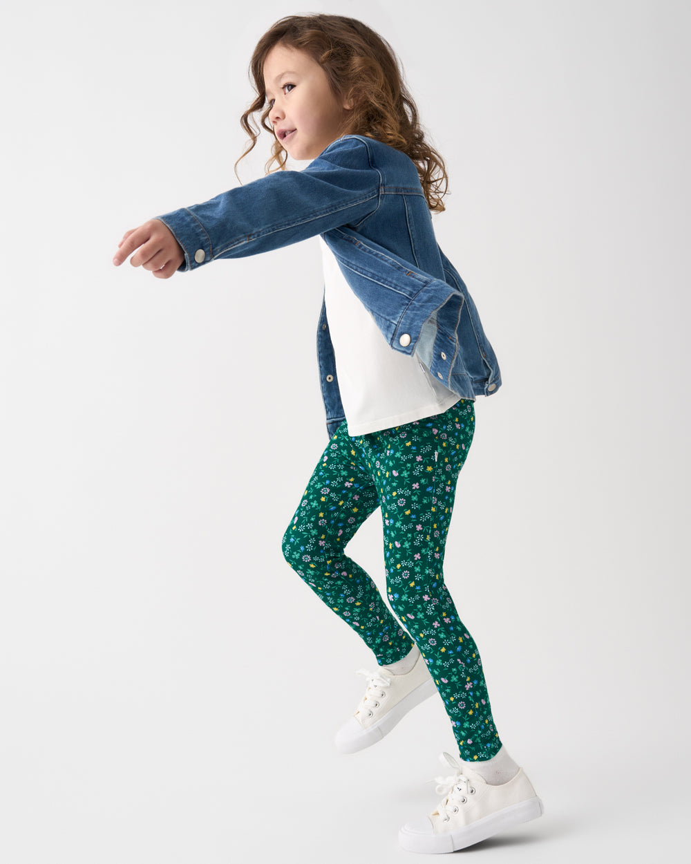 Child wearing the Emerald Meadow Legging with a white tee and jean jacket