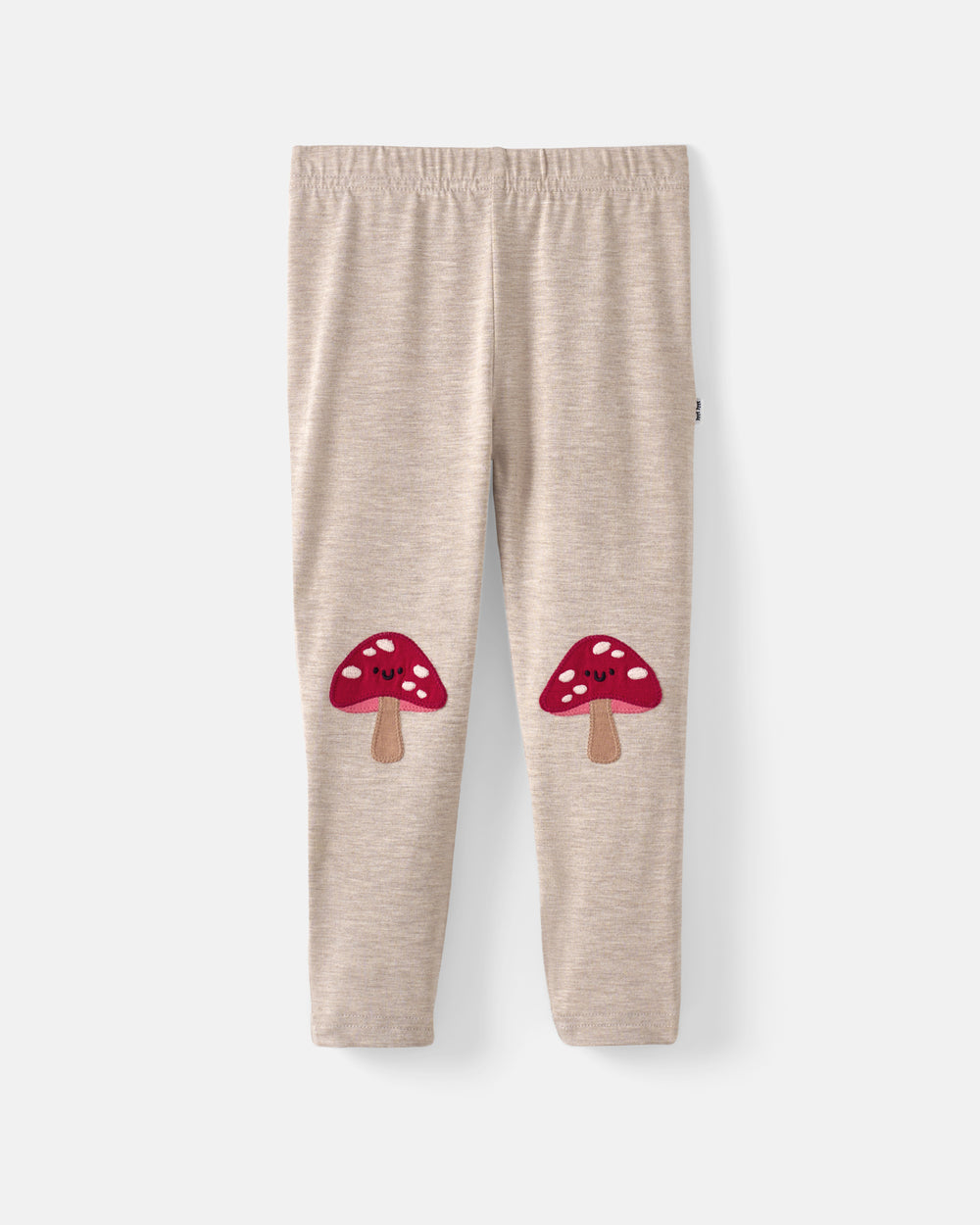 A pair of beige heathered children's leggings with two red mushroom graphics on the lower legs, displayed flat against a light gray background.