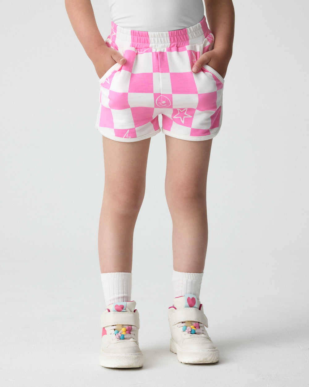 Girl wearing the Cheery Checks Pink Dolphin Shorts with sneakers