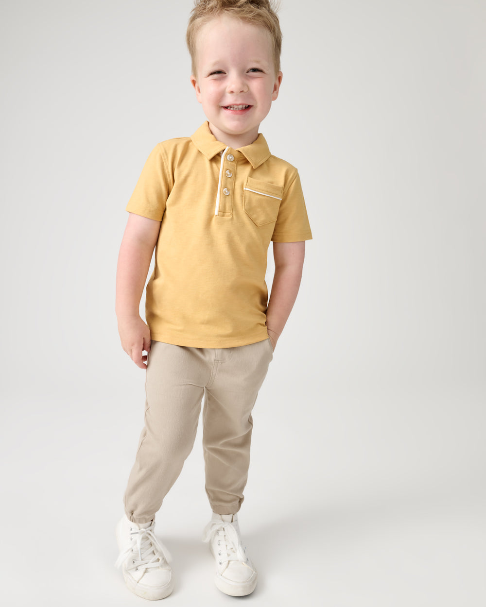 Boy wearing the Sand Drift Denim Jogger and Yellow Polo Top