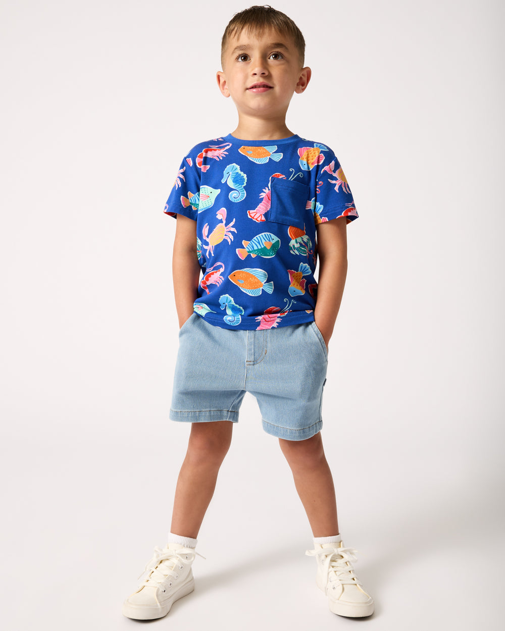 Boy wearing the Light Denim Chino Shorts with an ocean themed shirt