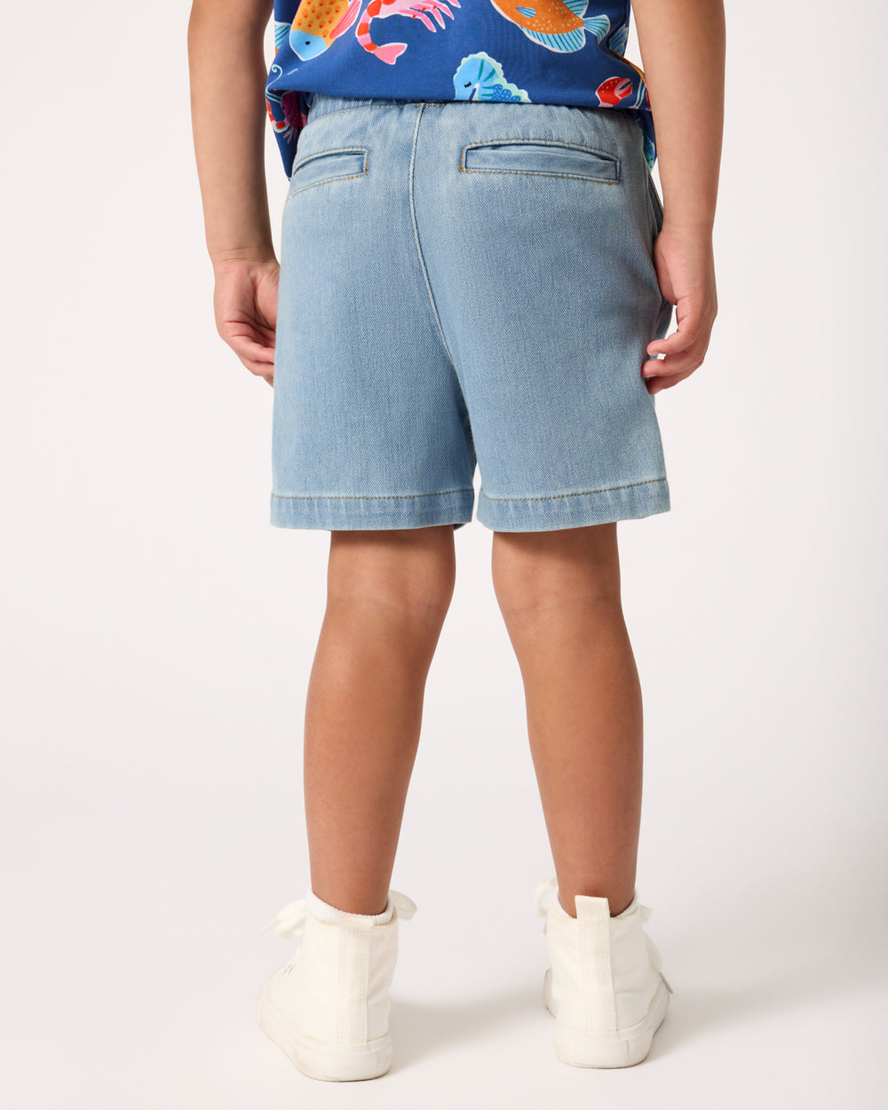 Back view of boy wearing the Light Denim Chino Shorts