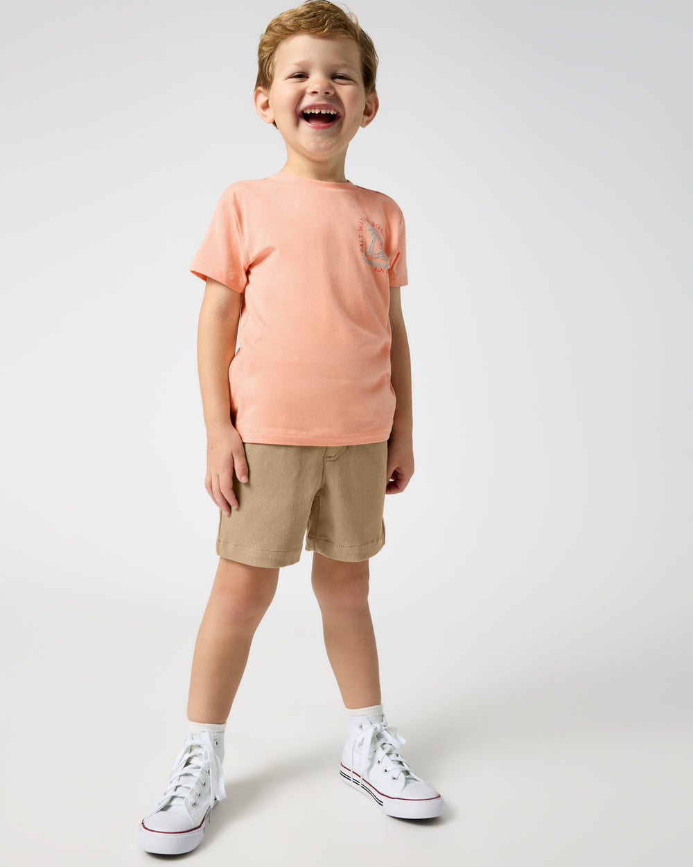 Boy wearing the Salt Water Social Club Relaxed Tee and khaki shorts