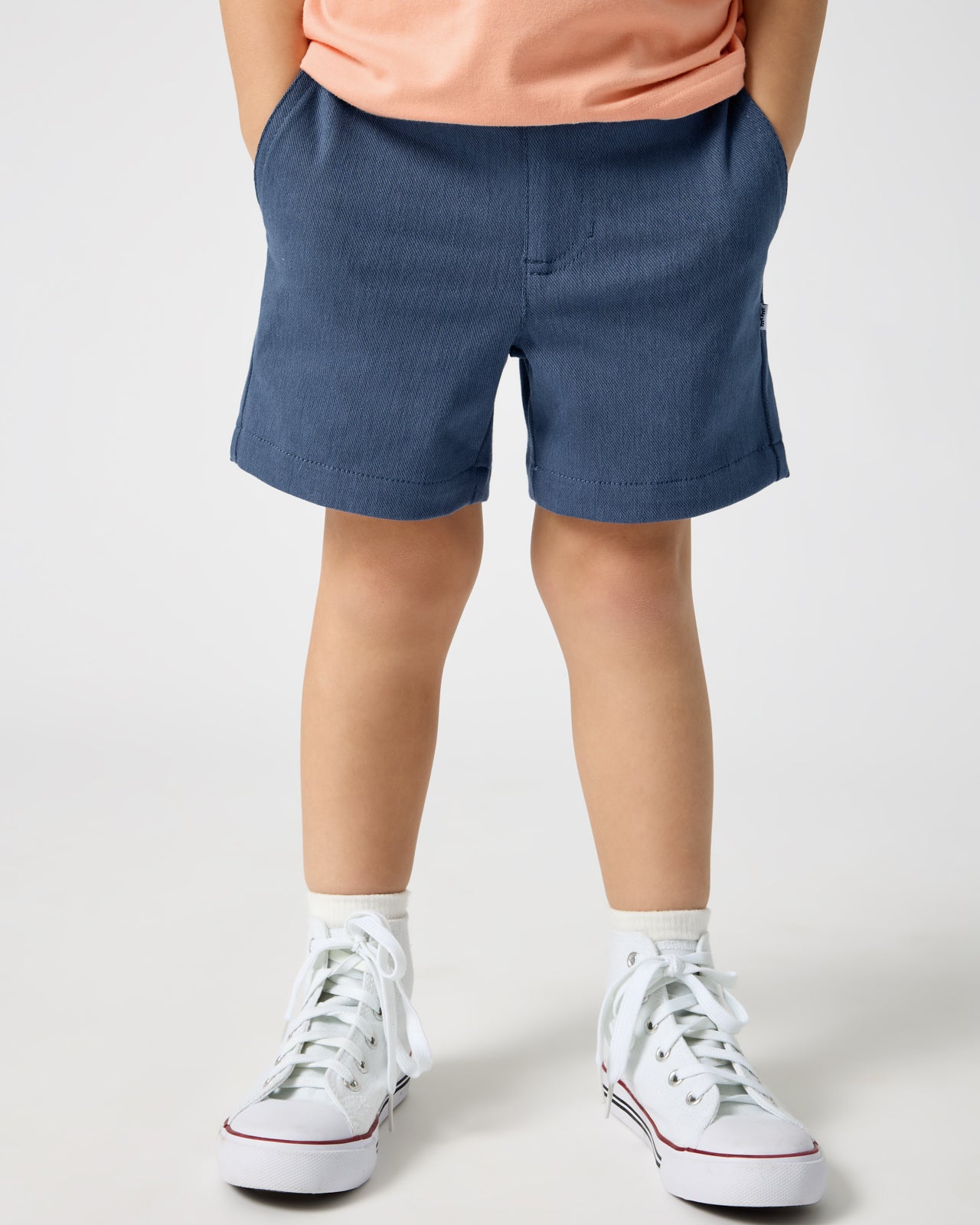 Boy wearing the Vintage Navy Chino Shorts with a peach tee