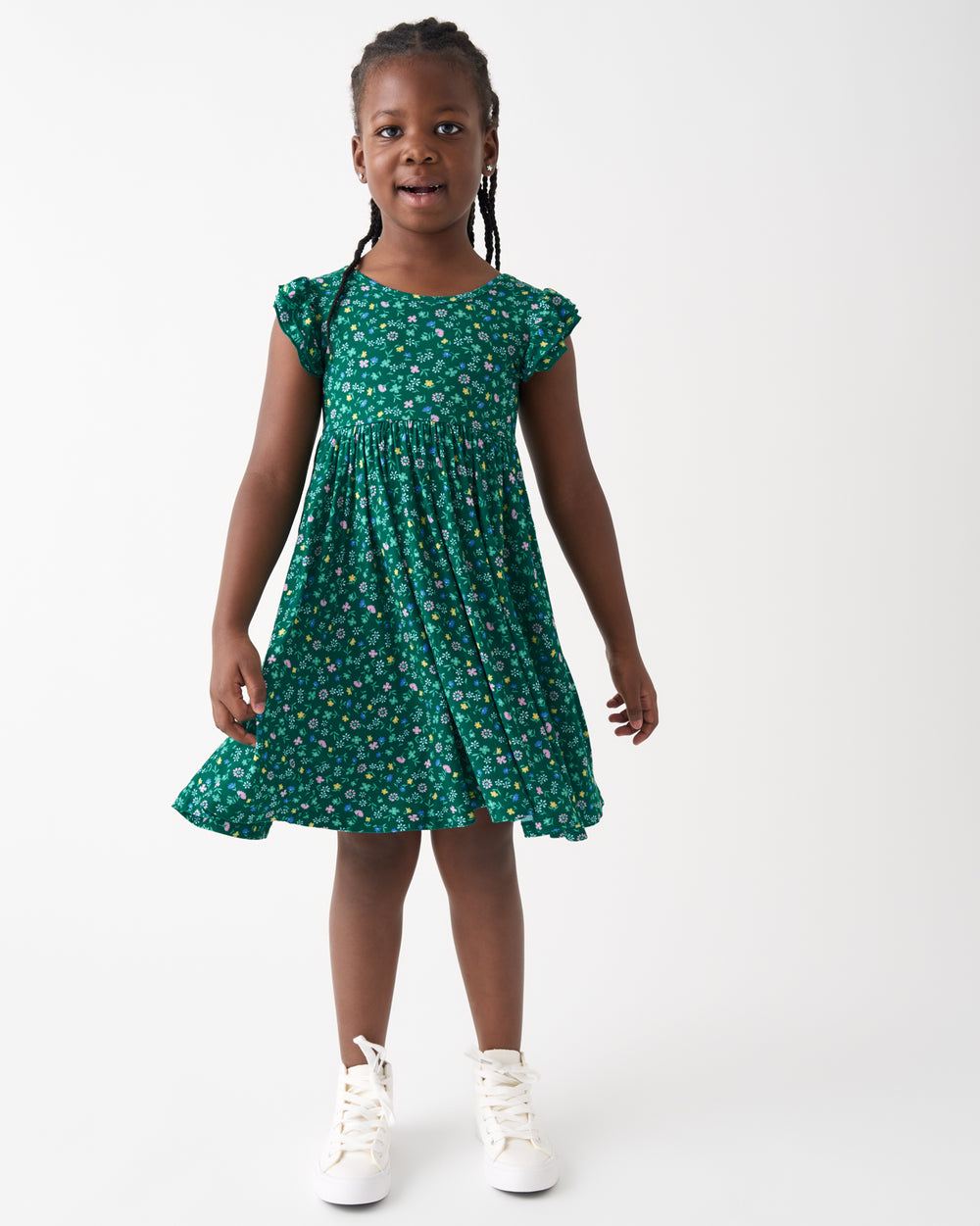 Standing girl wearing the Emerald Meadow Flutter Twirl Dress