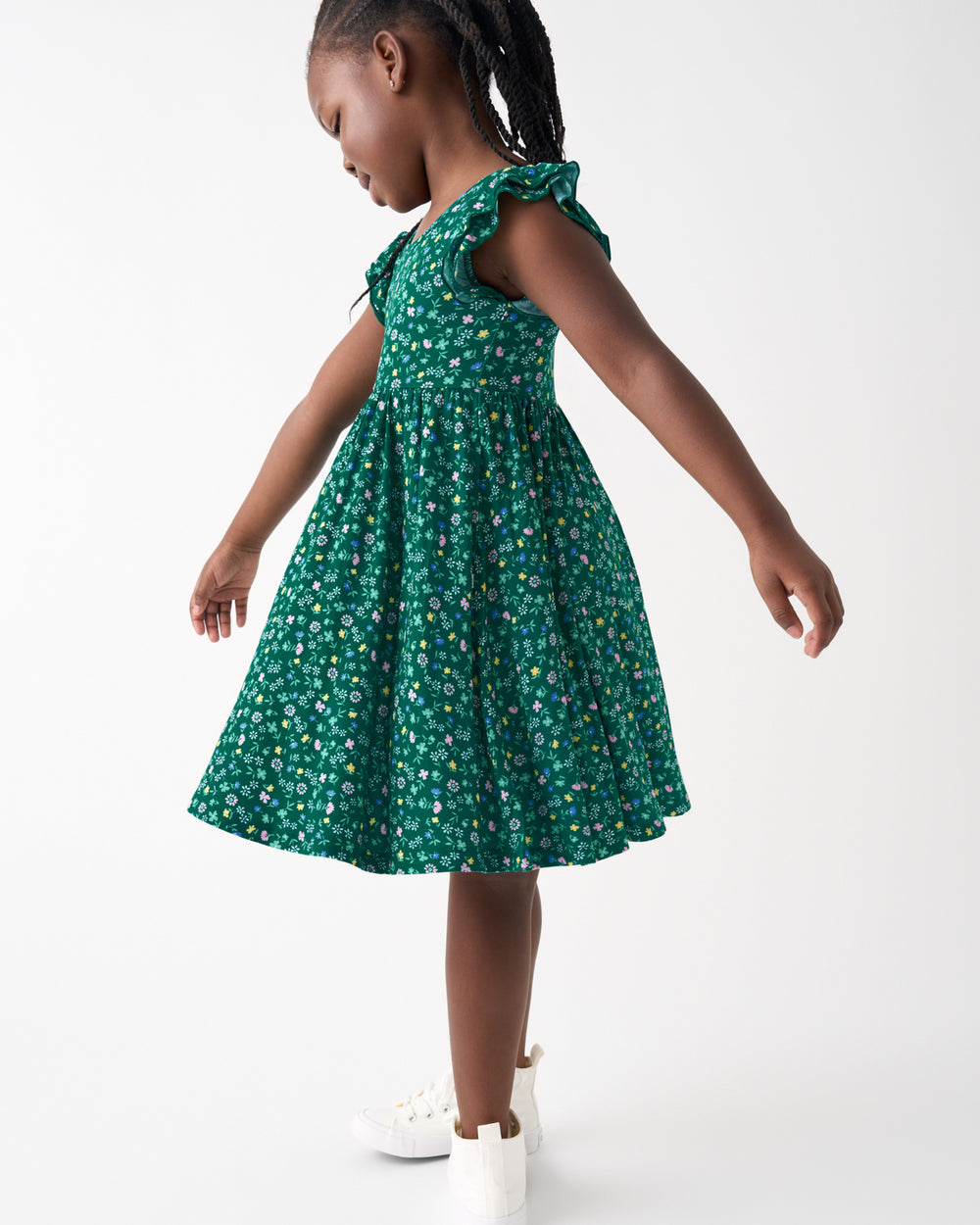 Side view of child wearing the Emerald Meadow Flutter Twirl Dress