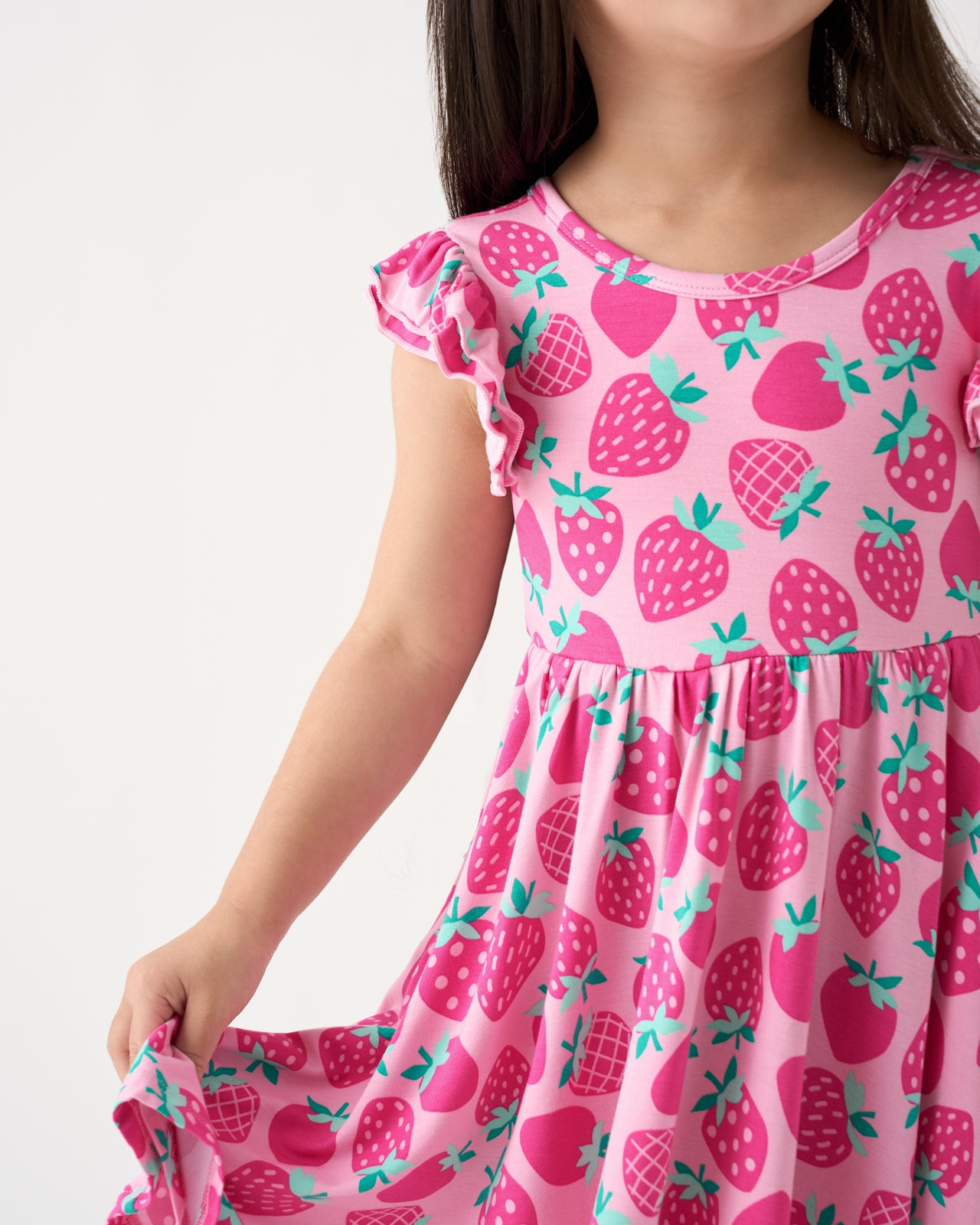 Close up of girl wearing the Sweet Strawberries Flutter Twirl Dress