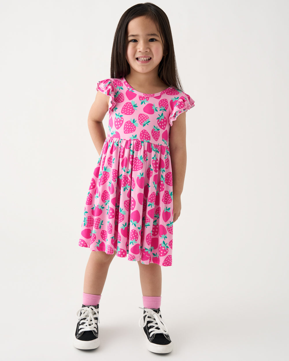 Standing girl wearing the Sweet Strawberries Flutter Twirl Dress