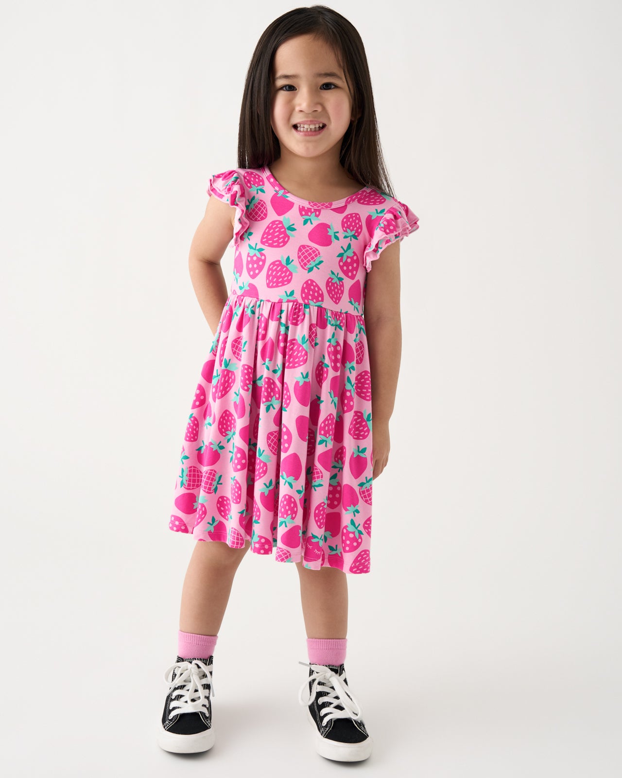 Standing girl wearing the Sweet Strawberries Flutter Twirl Dress