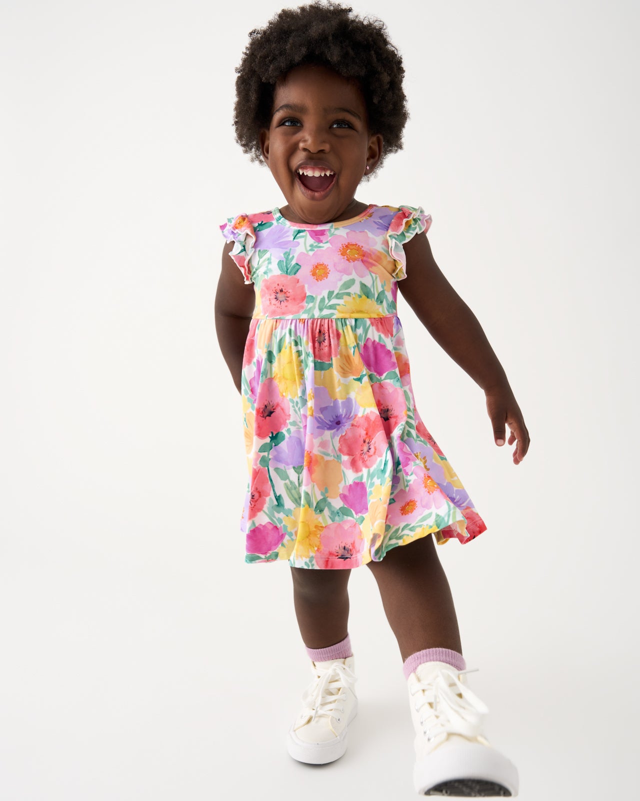 Walking child wearing the Watercolor Meadow Flutter Twirl Dress