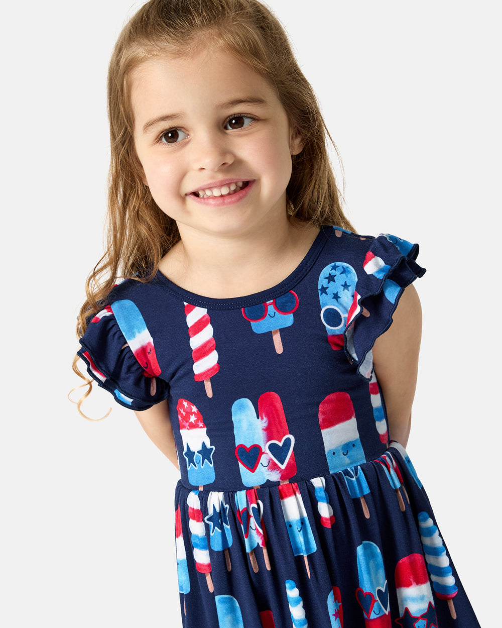 Close up of girl wearing the Sparkle Treats Flutter Skater Dress
