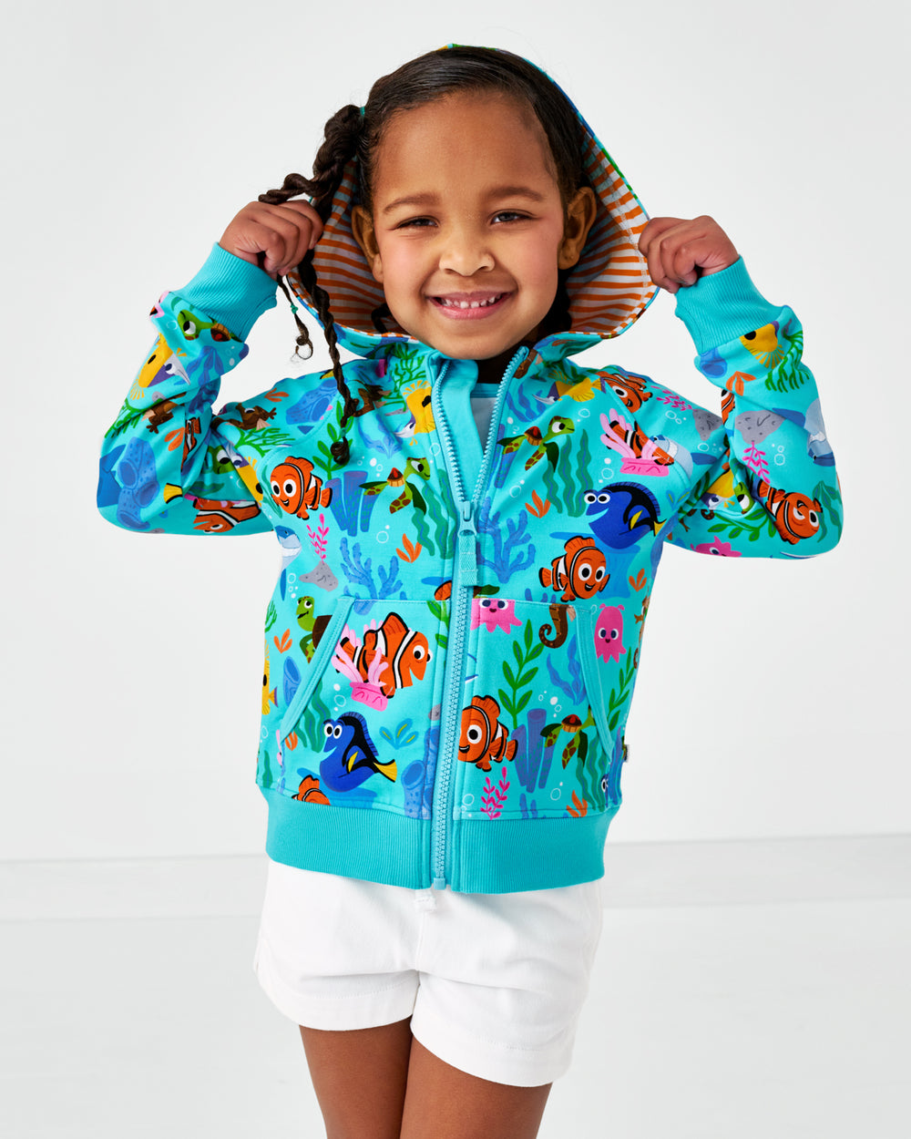 Close up of child wearing the Disney Nemo's Reef Zip Hoodie with the hood on