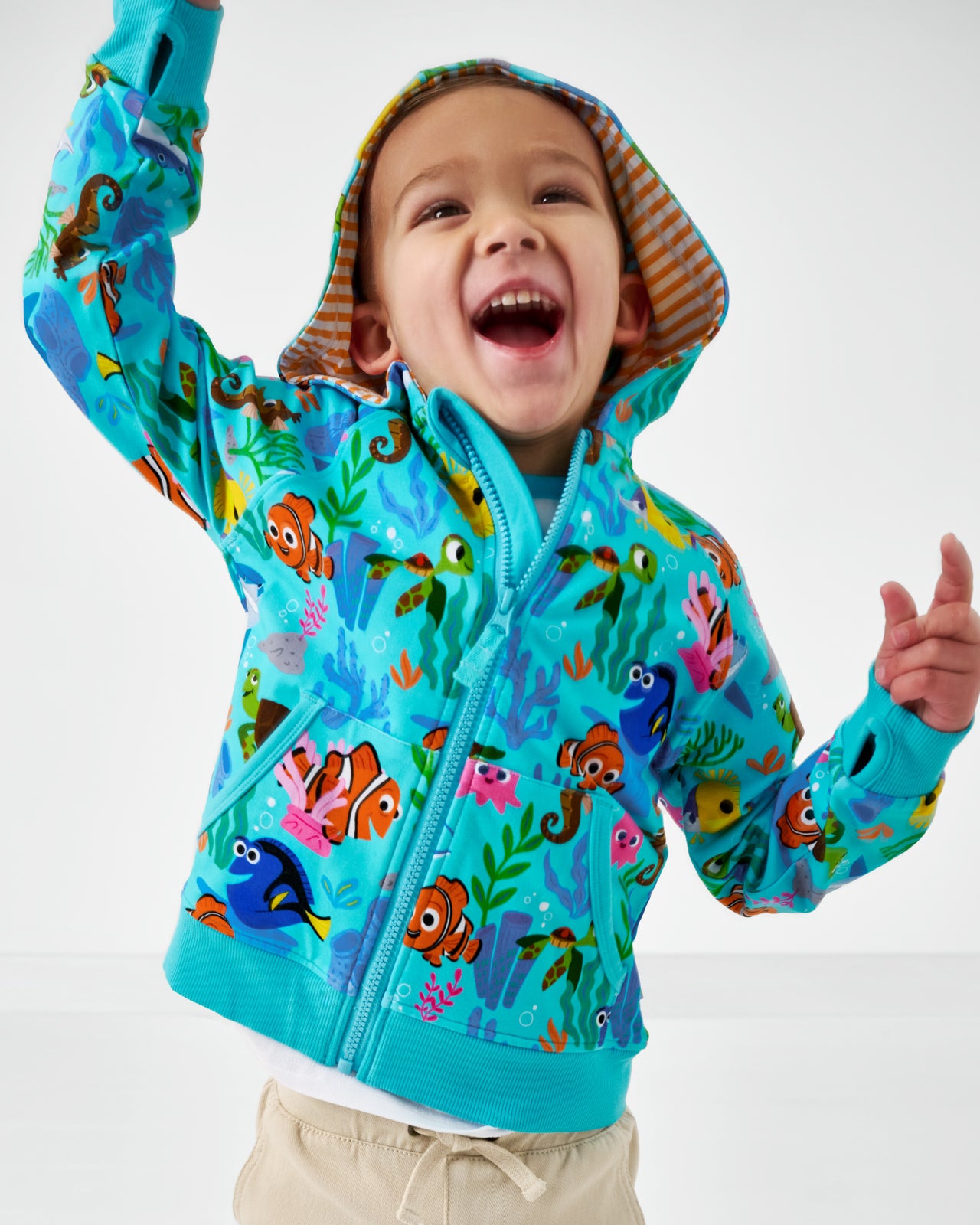 Posing child wearing the Disney Nemo's Reef Zip Hoodie