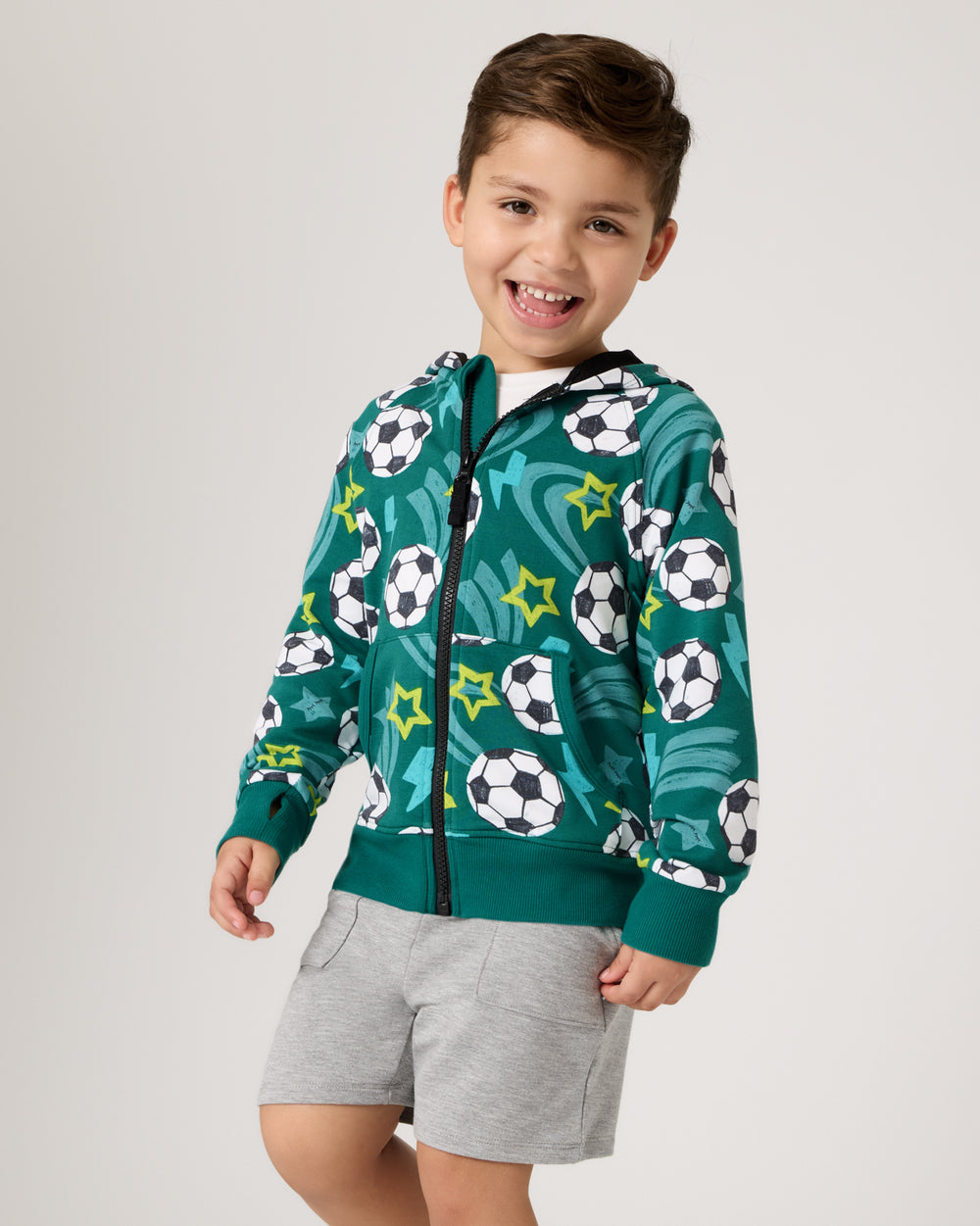 Close up of boy wearing the Soccer Stars Zip Hoodie with gray boys shorts