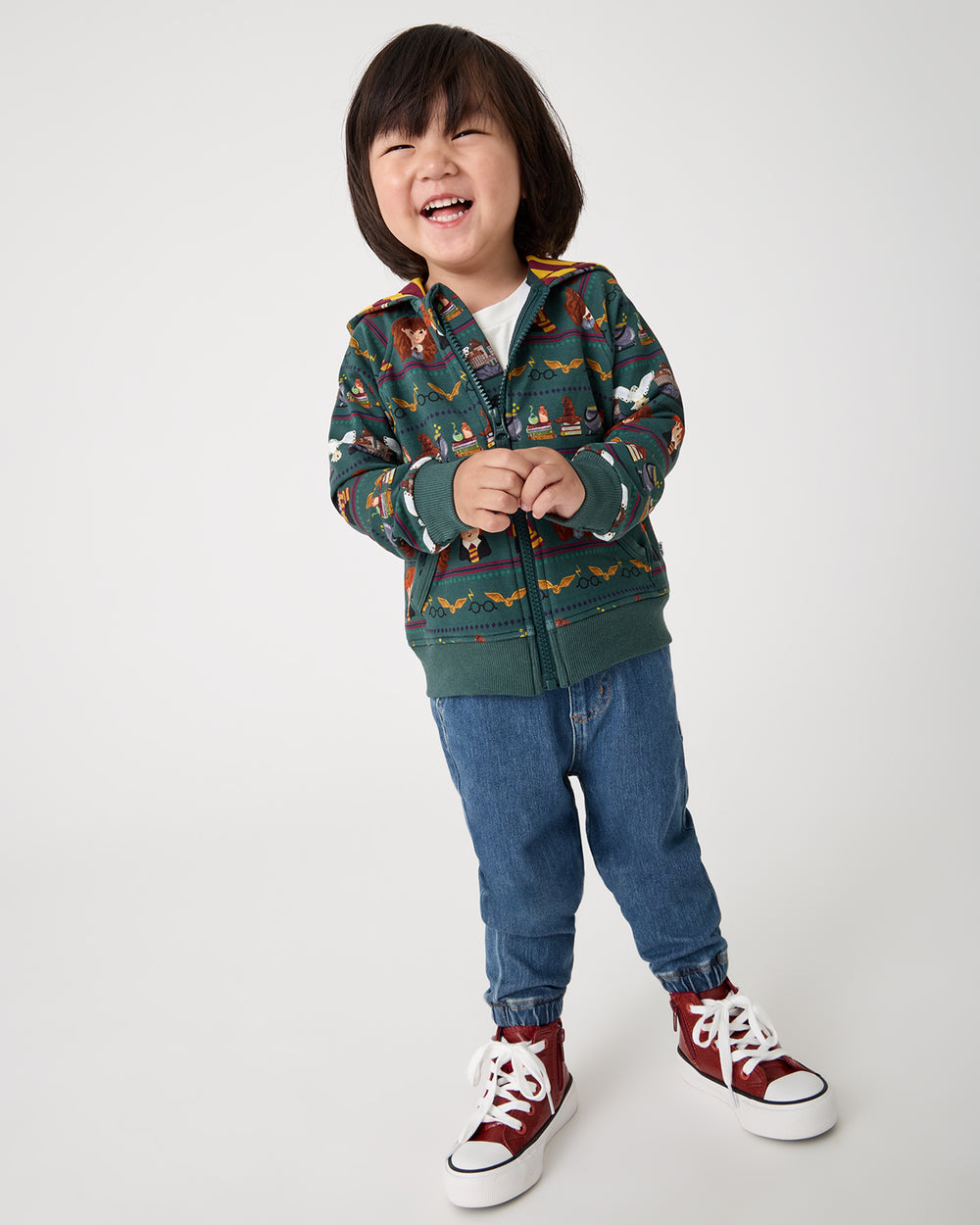 Child wearing the Harry Potter™ Spellbinding Studies Zip Hoodie with denim joggers