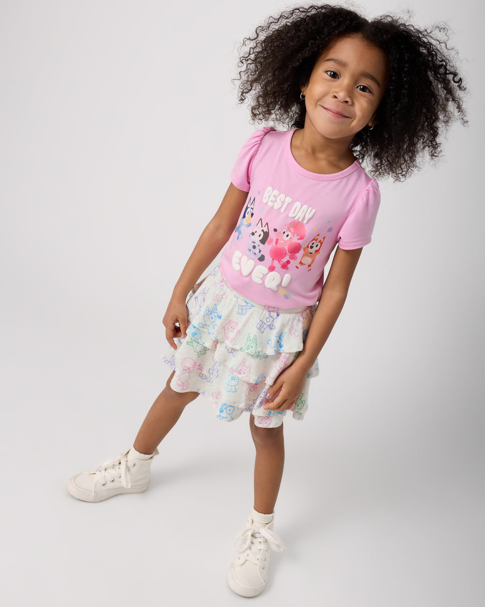 Girl wearing the Bluey Playtime Crew Ruffle Skort with a pink Bluey tee