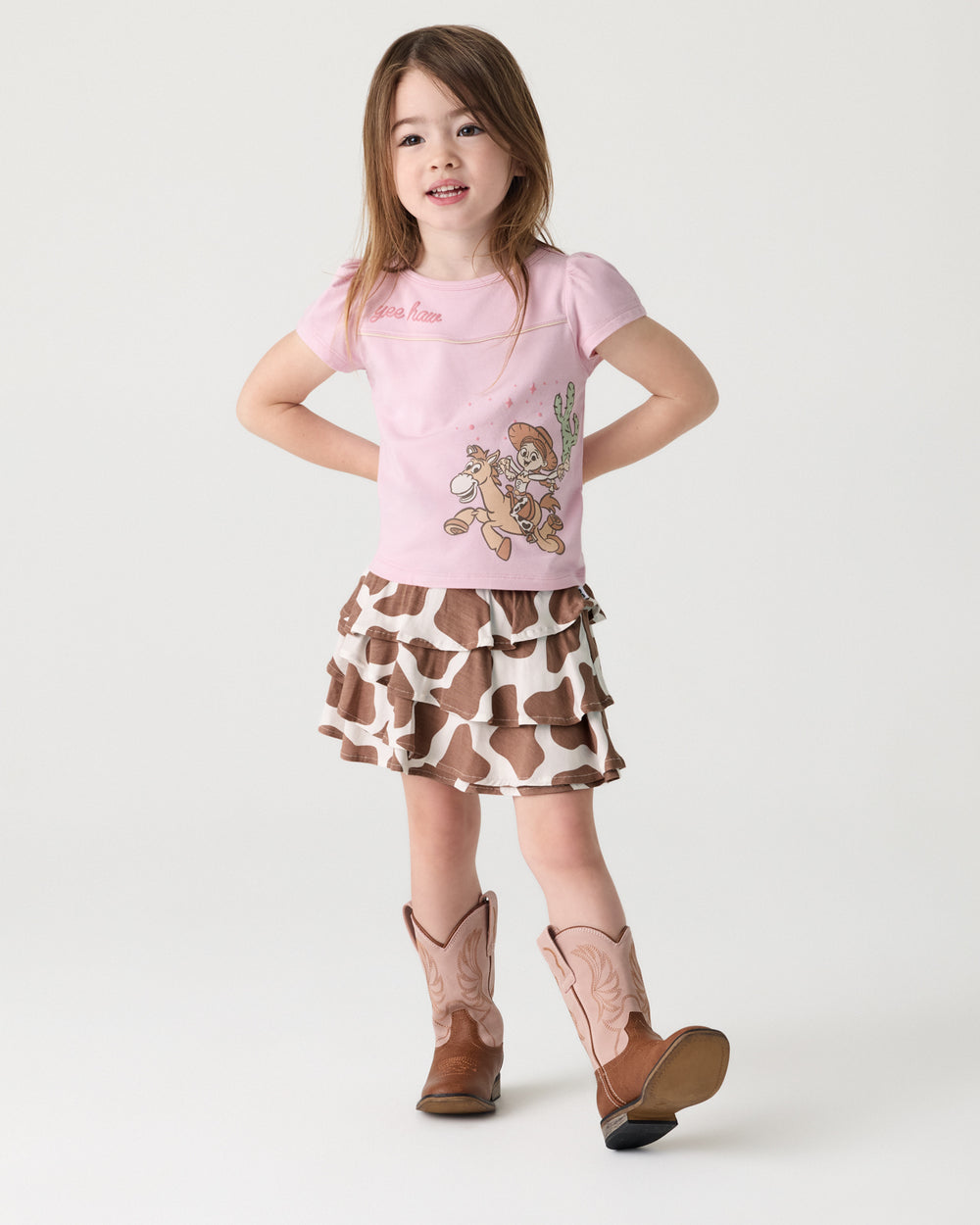 Girl wearing the Milk Chocolate Moo Crew Ruffle Skort with a Toy Story graphic tee