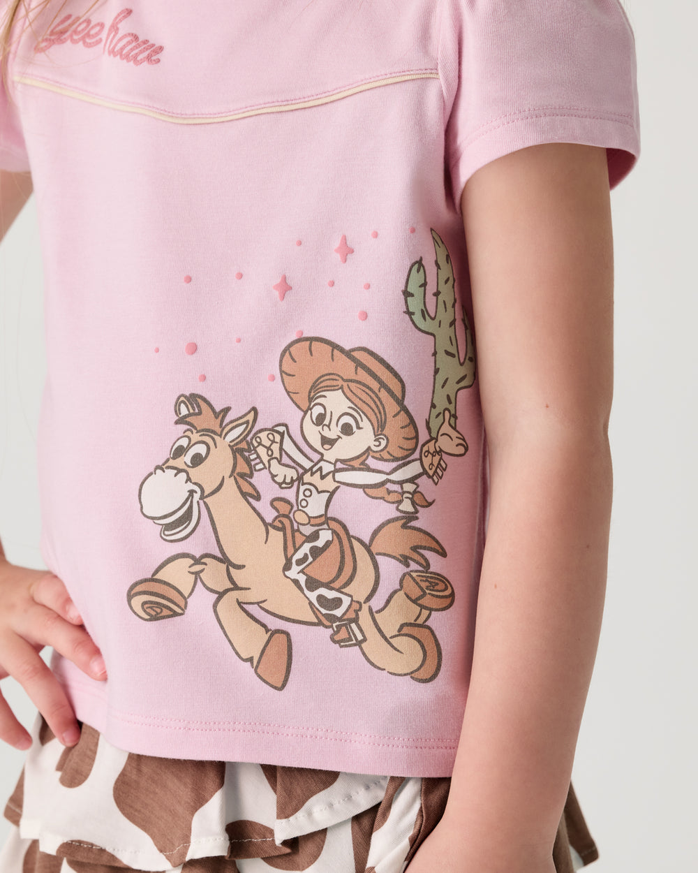 Close up of the graphic detail on the Disney & Pixar Howdy Jessie Puff Sleeve Tee