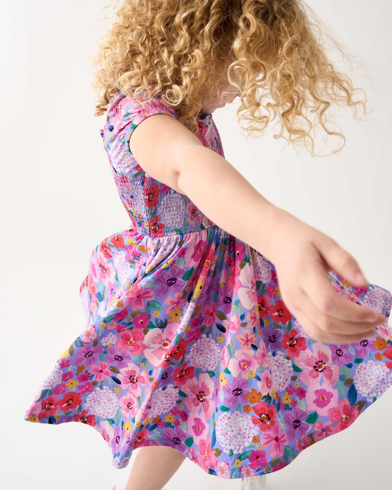 Girl in motion wearing the Sweet Sprigs Puff Sleeve Smocked Dress