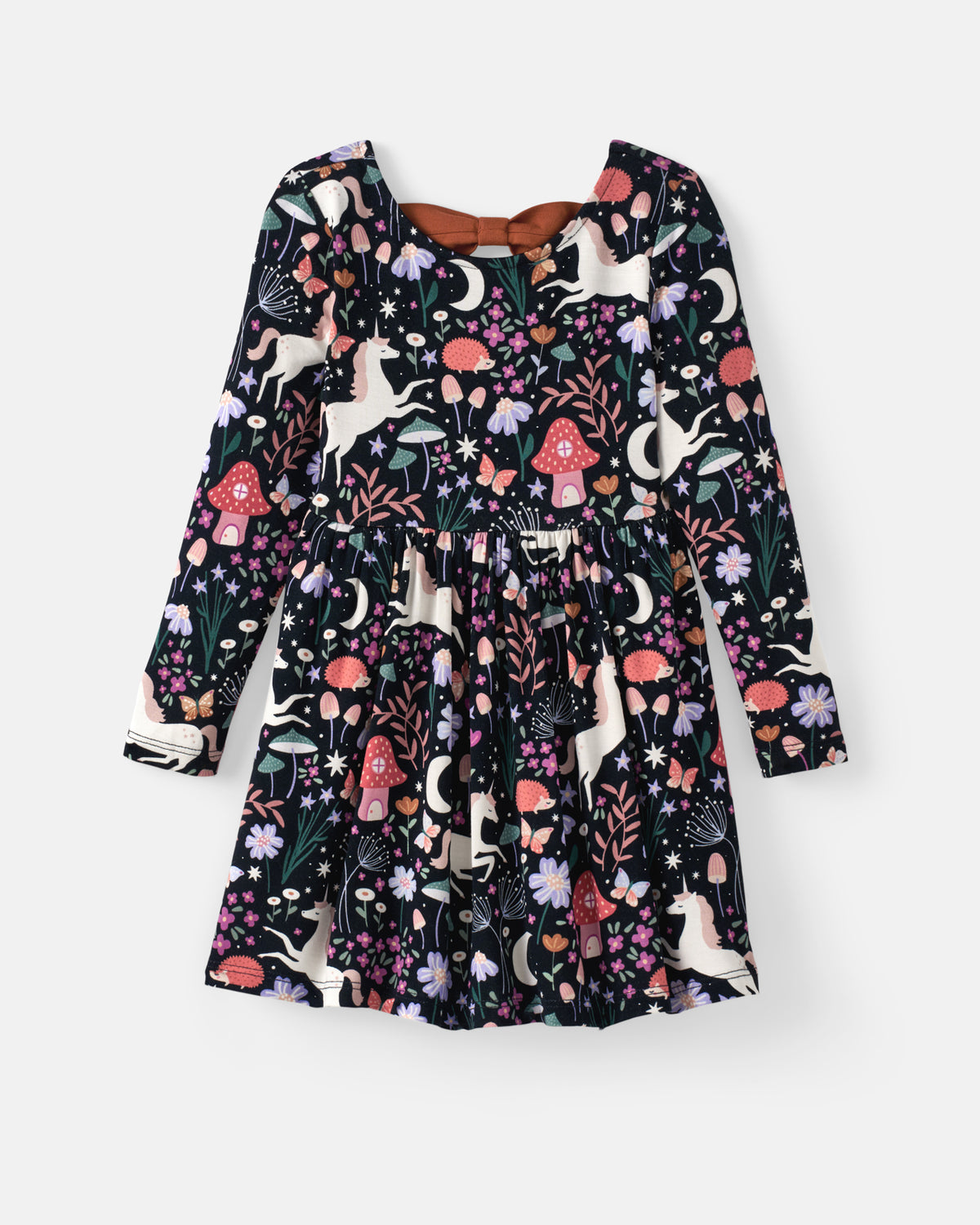 A long-sleeve children's dress with a whimsical woodland print featuring unicorns, mushrooms, flowers, and moons on a black background, shown flat against a light gray background.